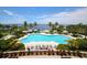 Expansive waterfront community pool features ample lounge seating, lush landscaping, and serene ocean views at 262 Sapphire Lake Dr # 202, Bradenton, FL 34209