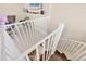 View down a modern, white spiral staircase with wood and light carpet flooring at 262 Sapphire Lake Dr # 202, Bradenton, FL 34209