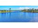 Scenic water view featuring a serene lake with a charming wooden bridge at 262 Sapphire Lake Dr # 202, Bradenton, FL 34209