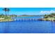 Beautiful water view highlighting a wooden bridge stretching across a calm, clear lake at 262 Sapphire Lake Dr # 202, Bradenton, FL 34209