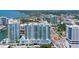 Aerial view of condo building featuring views of the water and surrounding city at 301 Quay Commons # 1208, Sarasota, FL 34236