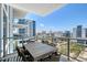 Outdoor condo patio seating provides views of the city at 301 Quay Commons # 1208, Sarasota, FL 34236