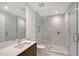 Contemporary bathroom features glass enclosed shower, large mirror and sleek design at 301 Quay Commons # 1208, Sarasota, FL 34236