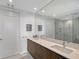 Bathroom features double sinks with modern finishes and glass shower at 301 Quay Commons # 1208, Sarasota, FL 34236