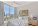 Light-filled bedroom with city views from large window and contemporary decor at 301 Quay Commons # 1208, Sarasota, FL 34236