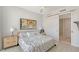 Bright bedroom features tiled floors and a sliding door to ensuite bathroom at 301 Quay Commons # 1208, Sarasota, FL 34236