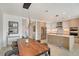 Elegant dining room with a modern chandelier, leading into the updated kitchen at 301 Quay Commons # 1208, Sarasota, FL 34236