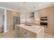 Modern kitchen featuring stainless steel appliances, an island with bar seating, and custom cabinetry at 301 Quay Commons # 1208, Sarasota, FL 34236