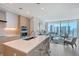 Open kitchen featuring a center island, bar seating, and modern appliances at 301 Quay Commons # 1208, Sarasota, FL 34236