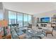 Comfortable living room boasting city views from expansive floor-to-ceiling windows at 301 Quay Commons # 1208, Sarasota, FL 34236