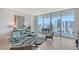 Chic living room with comfortable seating, artwork and spectacular city views at 301 Quay Commons # 1208, Sarasota, FL 34236