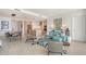 Bright, open-concept living room with modern furnishings and a view into the kitchen at 301 Quay Commons # 1208, Sarasota, FL 34236