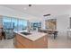 Open living space with an island, a view of the city skyline, and modern decor at 301 Quay Commons # 1208, Sarasota, FL 34236