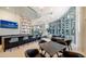 Contemporary lobby featuring a bar, chairs, tables, and sweeping city and water views at 301 Quay Commons # 1208, Sarasota, FL 34236