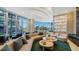 Inviting lobby space with ample seating, round tables, and lots of natural light at 301 Quay Commons # 1208, Sarasota, FL 34236