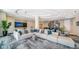 Well-lit lobby with sectional sofa, decorative pillows, and built-in bar with stools for seating at 301 Quay Commons # 1208, Sarasota, FL 34236