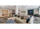 Elegant lobby with modular sofa, fireplace, TV, and sophisticated decor and color palate at 301 Quay Commons # 1208, Sarasota, FL 34236