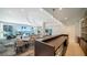 Bright lobby features pool views, modern lighting and furnishings, and bar area with countertops at 301 Quay Commons # 1208, Sarasota, FL 34236