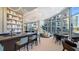 Contemporary lobby featuring a bar, chairs, tables, and sweeping city and water views at 301 Quay Commons # 1208, Sarasota, FL 34236