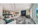Elegant lobby with modular sofa, fireplace, TV, and sophisticated decor and color palate at 301 Quay Commons # 1208, Sarasota, FL 34236