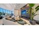 Stylish lounge area with sleek furniture, a large TV, and a cozy fireplace at 301 Quay Commons # 1208, Sarasota, FL 34236