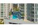 Rooftop pool area features sun loungers, umbrellas, and stunning city views at 301 Quay Commons # 1208, Sarasota, FL 34236