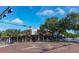 Street view of retail stores on a brick-paved intersection with pedestrians at 301 Quay Commons # 1208, Sarasota, FL 34236
