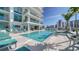 Resort-style swimming pool and hot tub with lounge seating at 301 Quay Commons # 1208, Sarasota, FL 34236