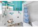 Bathroom with missing tiles and outdated shower curtain at 310 Avenida Milano, Sarasota, FL 34242
