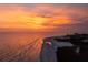 Scenic aerial view of a pristine beach at sunset, with gentle waves and a tranquil horizon at 310 Avenida Milano, Sarasota, FL 34242