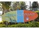 Charming Siesta Key Village sign surrounded by mature tropical landscaping at 310 Avenida Milano, Sarasota, FL 34242