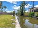 Waterfront property with lush landscaping, a private dock, and easy access to the open water at 310 Avenida Milano, Sarasota, FL 34242