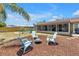 Inviting backyard with chairs around fire pit, perfect for relaxing and enjoying the outdoors at 3311 Florida Blvd, Bradenton, FL 34207