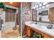 Stylish bathroom with brick accent wall, tile flooring and neutral-toned decor at 3311 Florida Blvd, Bradenton, FL 34207