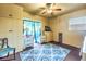 Comfortable bedroom featuring a ceiling fan and neutral-toned walls with a blue accent rug at 3311 Florida Blvd, Bradenton, FL 34207