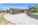 Charming single-story home with brick accents, a spacious driveway, and manicured landscaping at 3311 Florida Blvd, Bradenton, FL 34207