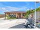 A brick facade highlights the front entrance with a glass-paneled front door and manicured landscaping at 3311 Florida Blvd, Bradenton, FL 34207