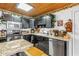 Charming kitchen featuring dark cabinets, granite countertops, and stainless steel appliances at 3311 Florida Blvd, Bradenton, FL 34207
