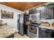 Compact kitchen featuring stainless steel appliances and dark cabinets at 3311 Florida Blvd, Bradenton, FL 34207
