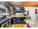 Charming kitchen featuring dark cabinets, granite countertops, and stainless steel appliances at 3311 Florida Blvd, Bradenton, FL 34207
