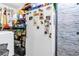 Functional laundry area with a washer, fridge, shelving, and storage space at 3311 Florida Blvd, Bradenton, FL 34207