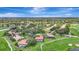 Beautiful aerial view showcasing residences nestled within a verdant golf course community featuring mature trees and scenic ponds at 3388 Highlands Bridge Rd, Sarasota, FL 34235