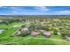 Picturesque aerial view of golf course homes, highlighting the community's lush green spaces, tranquil ponds, and premier location at 3388 Highlands Bridge Rd, Sarasota, FL 34235