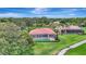 Aerial view of a home with a screened pool, surrounded by lush greenery, with a view of the surrounding neighborhood at 3388 Highlands Bridge Rd, Sarasota, FL 34235