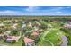 Stunning aerial view of a golf course community with lush landscaping, serene ponds, and beautiful single-Gathering homes at 3388 Highlands Bridge Rd, Sarasota, FL 34235