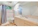 Bathroom with a bathtub, neutral tile, large mirror, and window at 3388 Highlands Bridge Rd, Sarasota, FL 34235