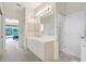 Bathroom with neutral tile countertops, and view to the bedroom at 3388 Highlands Bridge Rd, Sarasota, FL 34235