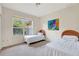 Cozy bedroom featuring twin beds, a bright window with garden view, and carpet floors at 3388 Highlands Bridge Rd, Sarasota, FL 34235
