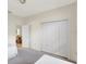 Bedroom featuring neutral carpet, a large closet, and easy access to another room at 3388 Highlands Bridge Rd, Sarasota, FL 34235