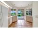 Well-lit kitchen with view to the pool features neutral countertops, terracotta tile floor, and ample natural light at 3388 Highlands Bridge Rd, Sarasota, FL 34235